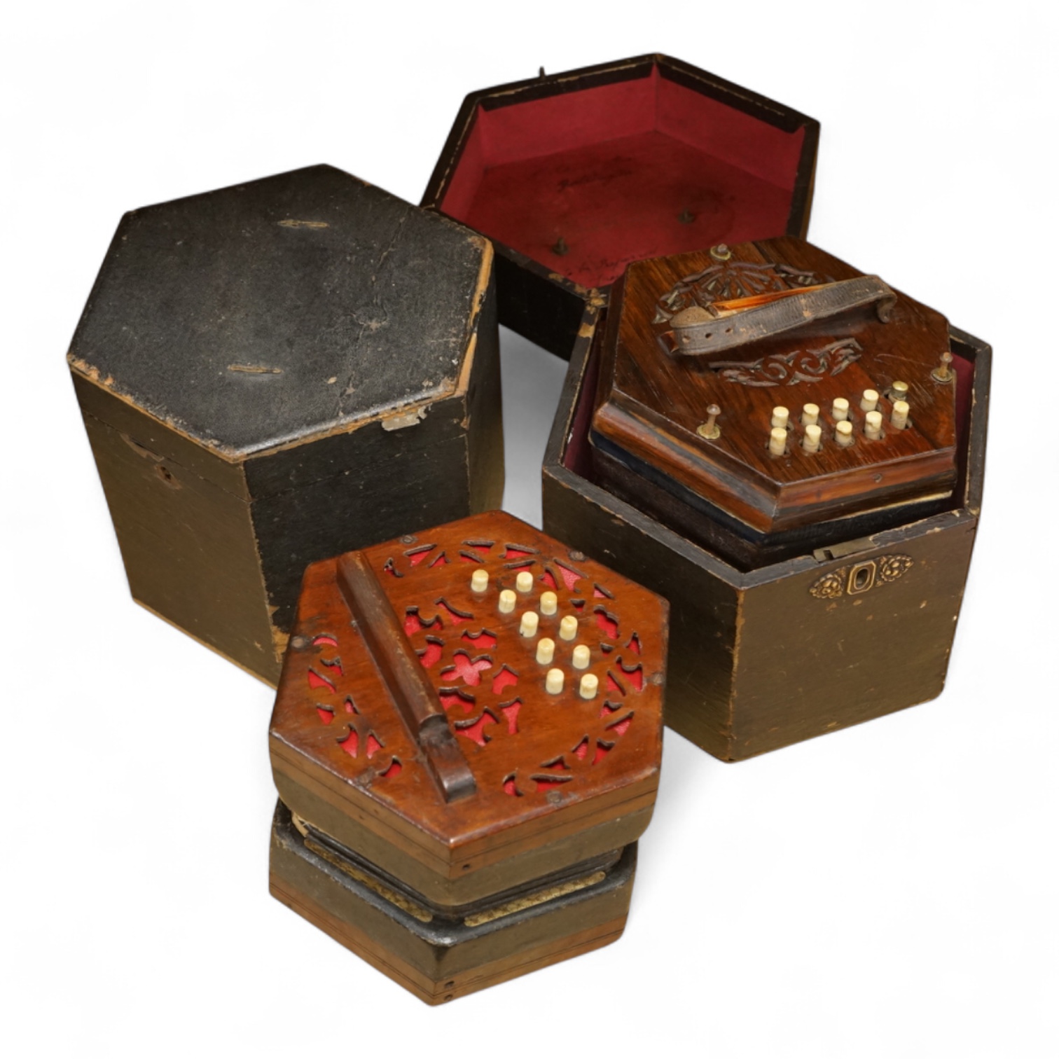 Two cased concertinas; one in mahogany with original paper label for Lachenal & Co., London, the other in rosewood (a.f.)